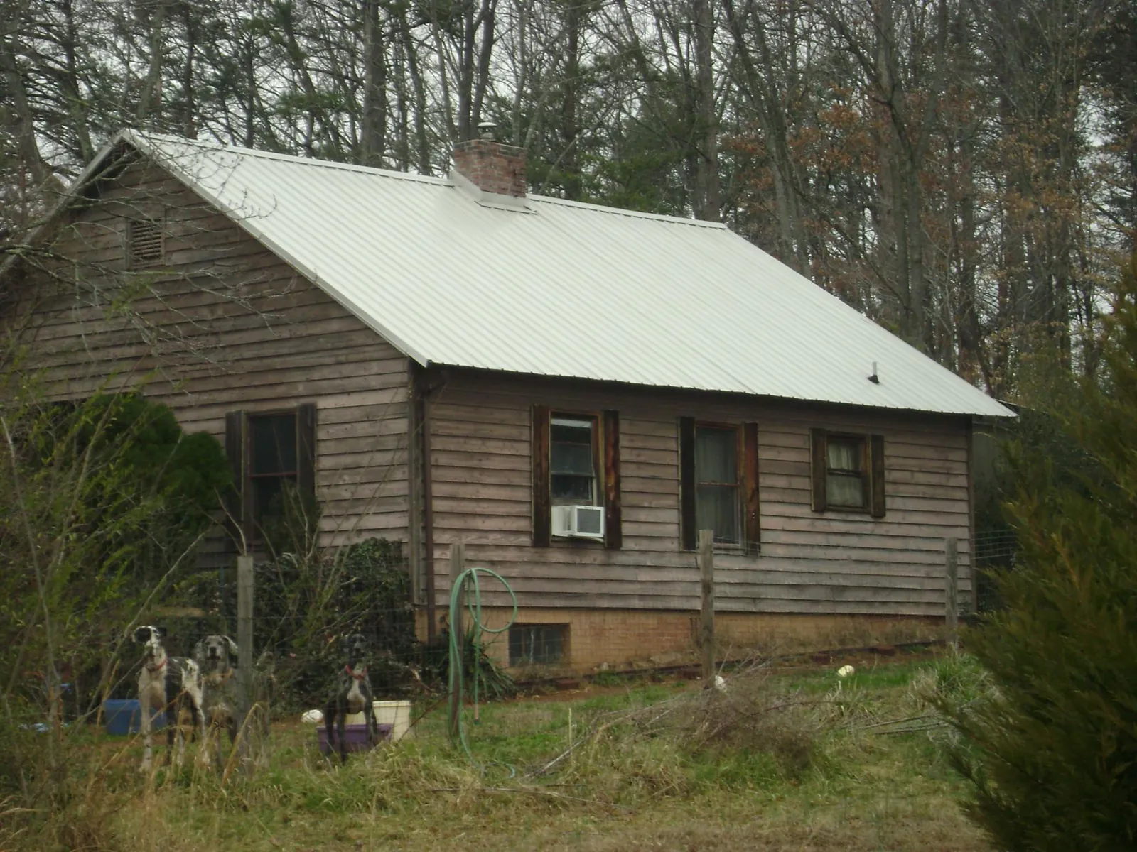 White metal roof on an old wood sided farmhouse, from a Metal Roof Installation job in Crooksville